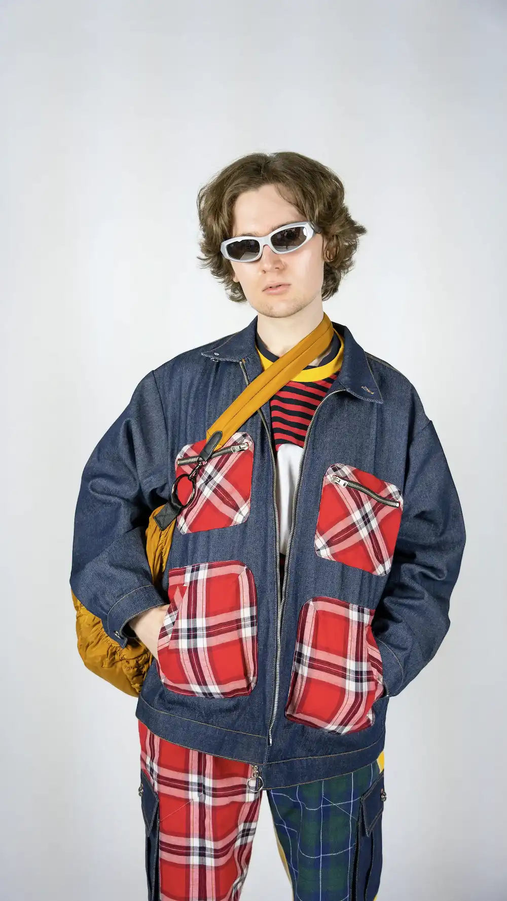 Male model wearing TRKSTR Denim Chore Jacket with a mustard-coloured bag